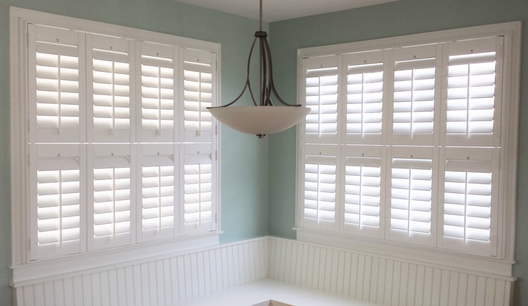 Soft green wall in Raleigh kitchen with shutters.